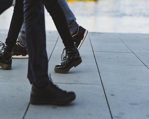 Person walking calmly with comfortable shoes on a sidewalk