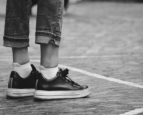 Detail of comfortable everyday footwear on urban pavement